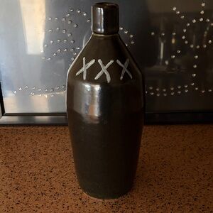Heavy earthenware  black jug XXX.